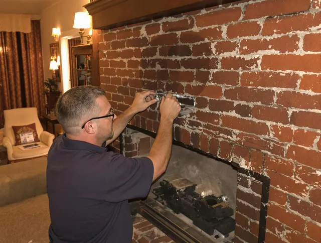 Middleburg Heights Chimney Sweep expert fixing a fireplace in Middleburg Heights, OH